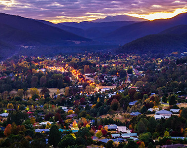 aerial photograph of town nestled amongst mountains